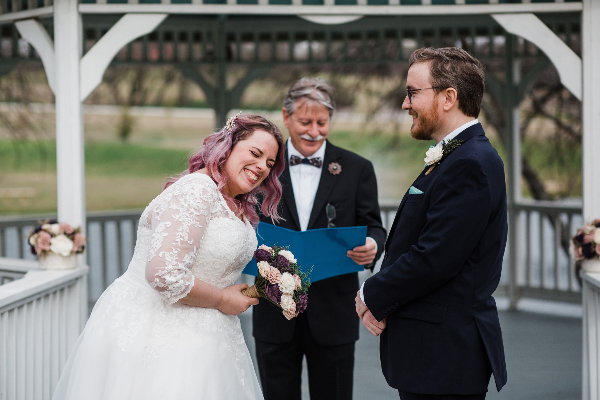 bride and groom laughing at the wedding altar